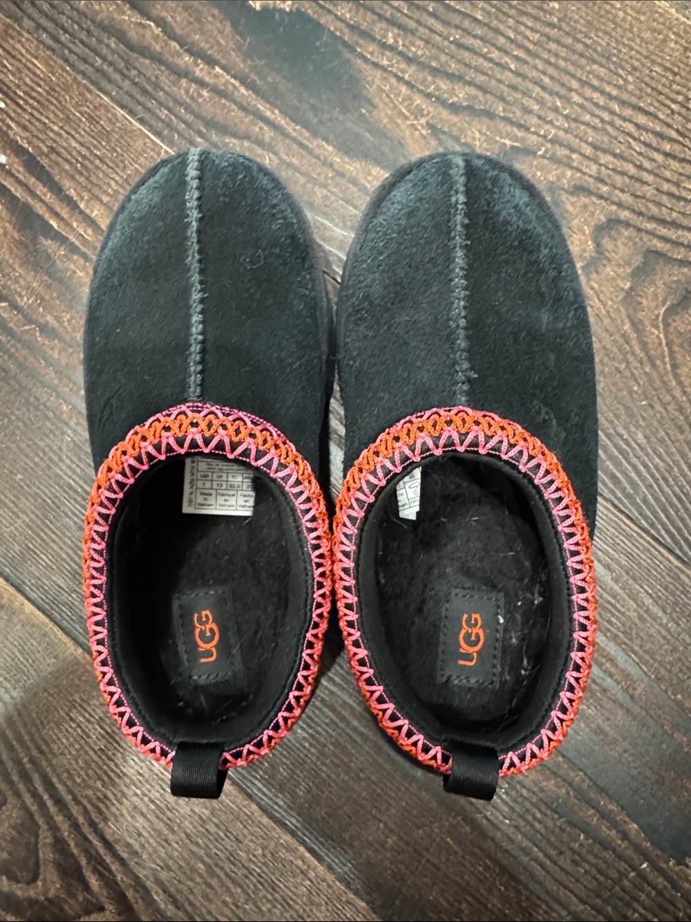 UGG Kids Black Slip-On Slippers with Pink & Orange Stitch Trim